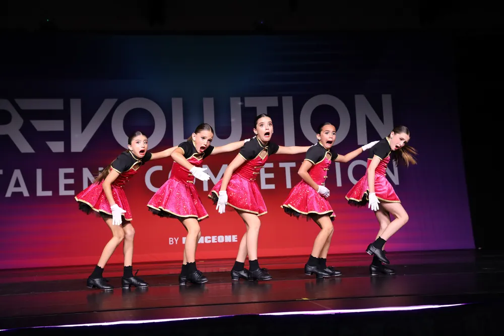 Five MSDC dancers mid-number in pink on the national competition stage